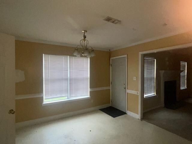 unfurnished dining area featuring a chandelier and ornamental molding