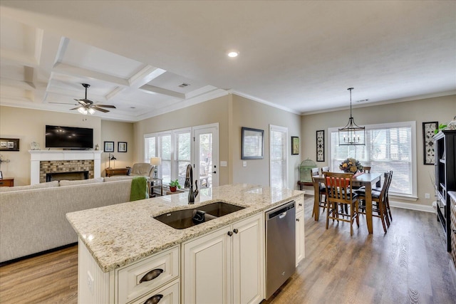 186 Tara Dr, Mccormick, SC 29835 - kitchen featuring light wood-style flooring, dishwasher, a sink, ceiling fan with notable chandelier, and a fireplace