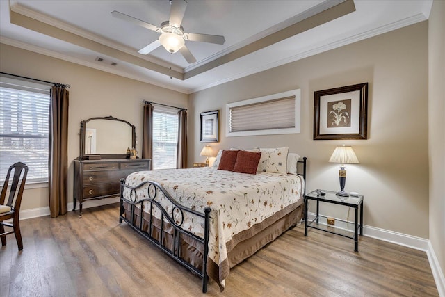 186 Tara Dr, Mccormick, SC 29835 - bedroom with wood finished floors, a tray ceiling, crown molding, visible vents, and baseboards