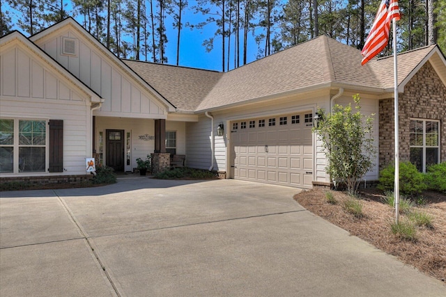 186 Tara Dr, Mccormick, SC 29835 - view of front of property featuring a shingled roof, board and batten siding, driveway, and a garage
