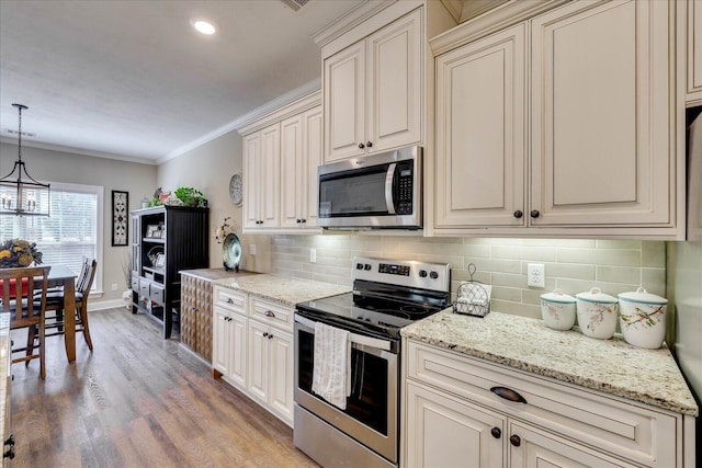 186 Tara Dr, Mccormick, SC 29835 - kitchen featuring cream cabinets, stainless steel appliances, and decorative backsplash