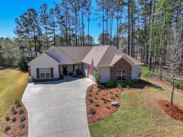 186 Tara Dr, Mccormick, SC 29835 - view of front facade featuring driveway, board and batten siding, an attached garage, a shingled roof, and a front lawn