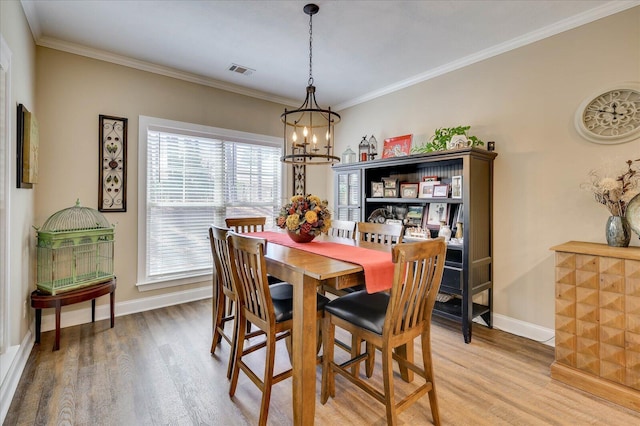 186 Tara Dr, Mccormick, SC 29835 - dining area with a chandelier, ornamental molding, light wood-type flooring, and visible vents
