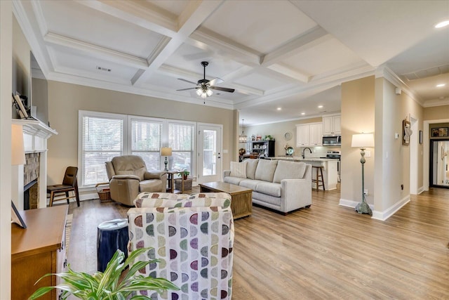 186 Tara Dr, Mccormick, SC 29835 - living room featuring a fireplace, ceiling fan, baseboards, and light wood-style floors