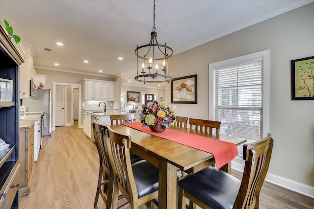 186 Tara Dr, Mccormick, SC 29835 - dining room with a notable chandelier, recessed lighting, baseboards, light wood finished floors, and crown molding