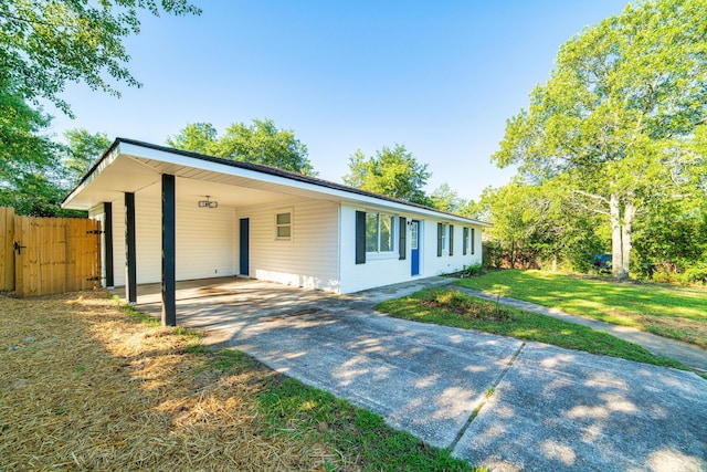 ranch-style house with driveway, a front lawn, fence, and an attached carport