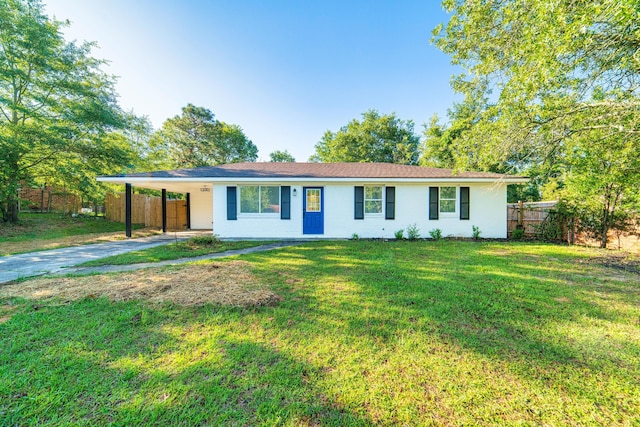 single story home with driveway, an attached carport, a front lawn, and fence