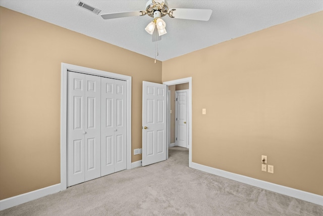 unfurnished bedroom featuring visible vents, baseboards, a closet, and carpet flooring