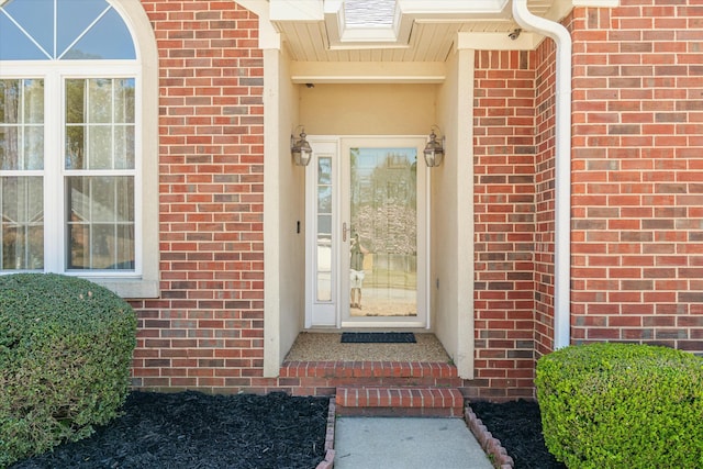 property entrance featuring brick siding