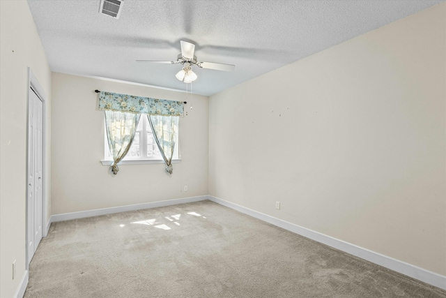 unfurnished bedroom featuring baseboards, visible vents, carpet floors, and a closet