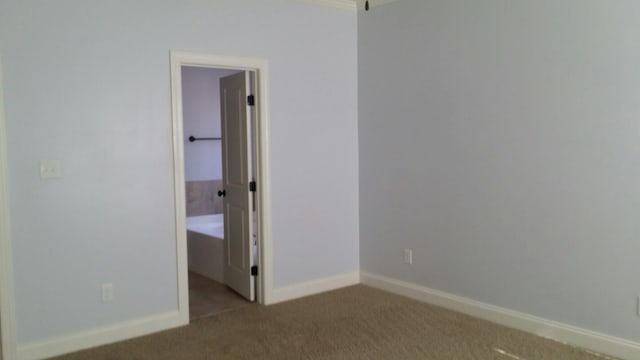 unfurnished bedroom featuring carpet flooring and baseboards