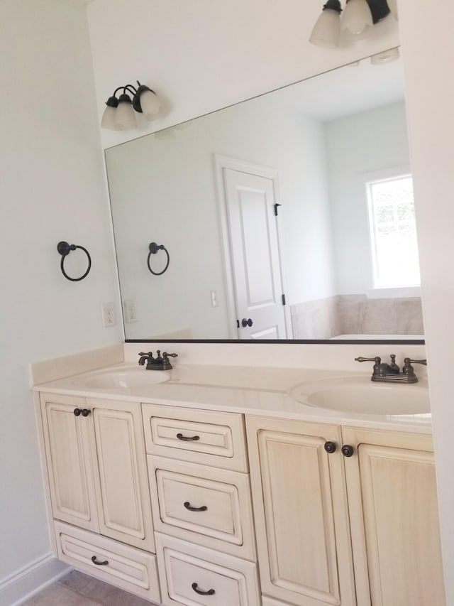 full bath with a sink and double vanity