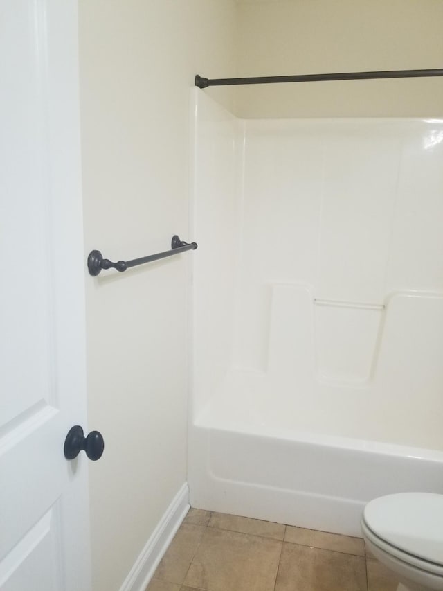 bathroom featuring shower / bath combination, toilet, and tile patterned floors