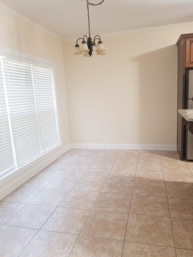 unfurnished dining area with light tile patterned floors, baseboards, ornamental molding, and a notable chandelier