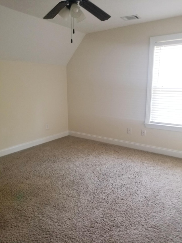 bonus room featuring lofted ceiling, baseboards, visible vents, and carpet flooring