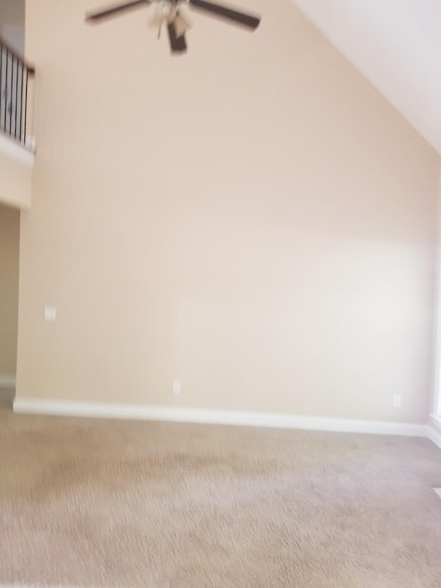 interior space featuring lofted ceiling, ceiling fan, and baseboards