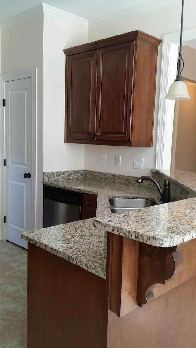 kitchen featuring dishwasher, light stone counters, hanging light fixtures, crown molding, and a sink