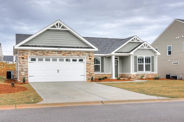 craftsman inspired home with central AC, a garage, and a front yard