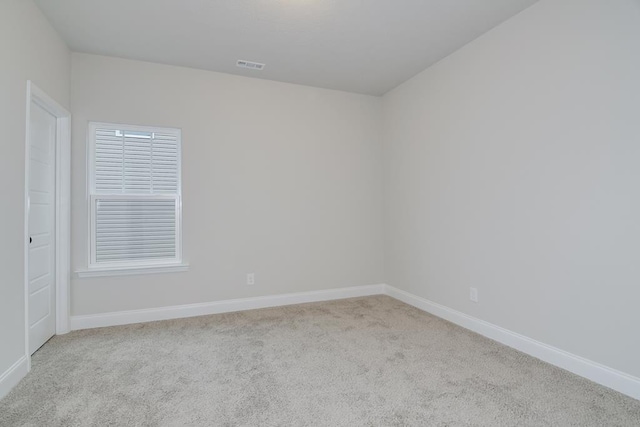 unfurnished room featuring light carpet