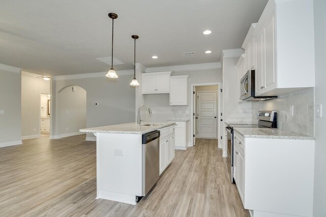 kitchen with white cabinetry, stainless steel appliances, sink, and a kitchen island with sink