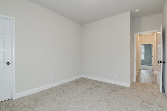 unfurnished room featuring light colored carpet