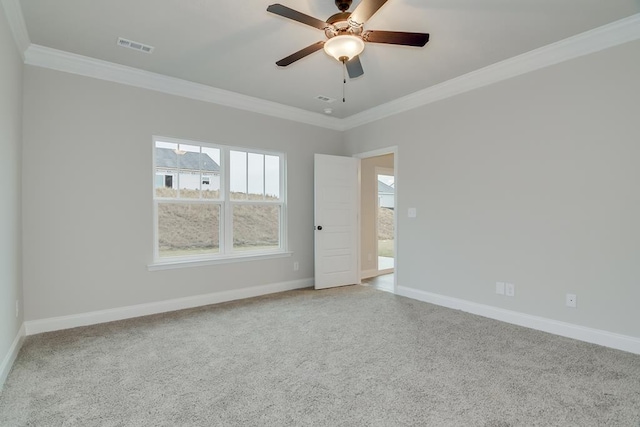 empty room with crown molding, carpet, and ceiling fan