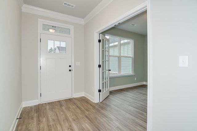 entrance foyer with crown molding and light hardwood / wood-style flooring