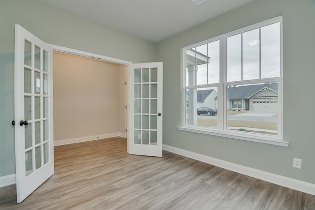 interior space with french doors and light wood-type flooring