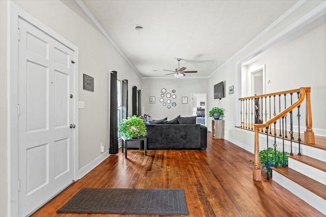 entrance foyer with crown molding, baseboards, stairs, wood finished floors, and a ceiling fan