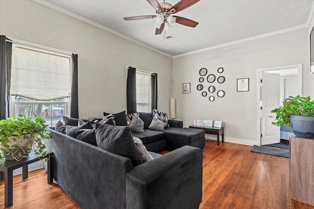 living area with crown molding, wood finished floors, and ceiling fan