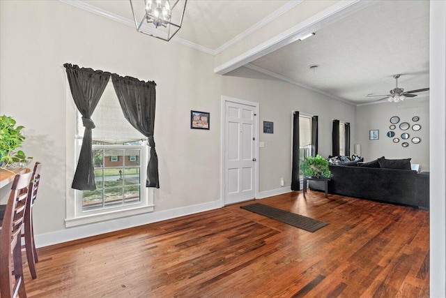 entryway with crown molding, baseboards, and wood finished floors