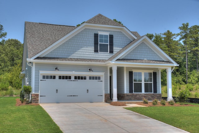 craftsman inspired home featuring stone siding, driveway, a front lawn, and roof with shingles