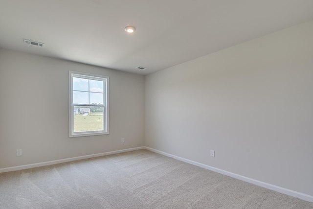 unfurnished room with visible vents, carpet flooring, and baseboards