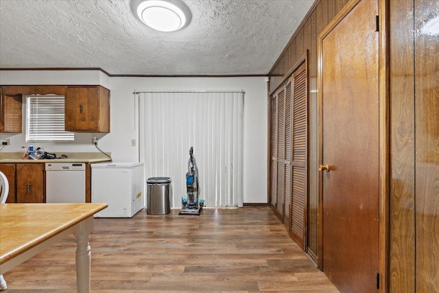 kitchen featuring dishwasher, refrigerator, wood-type flooring, and ornamental molding