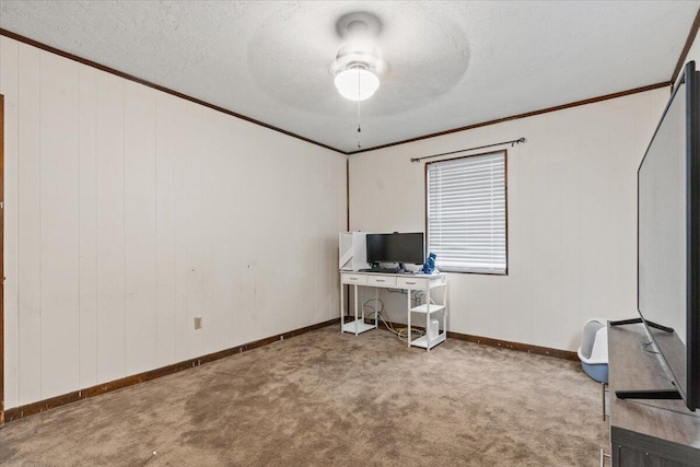 carpeted office space with a textured ceiling, ceiling fan, and ornamental molding