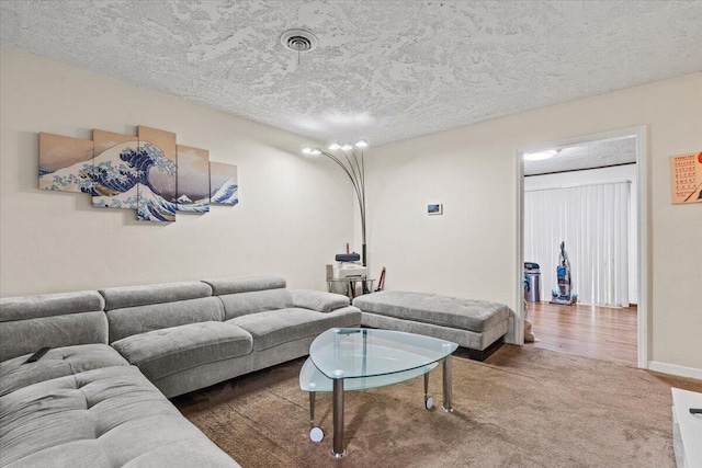 living room with a textured ceiling and carpet floors