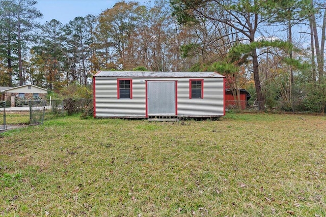 view of outdoor structure featuring a lawn