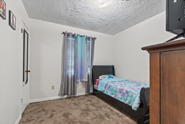 carpeted bedroom with a textured ceiling