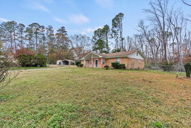 view of front facade featuring a front yard and a carport