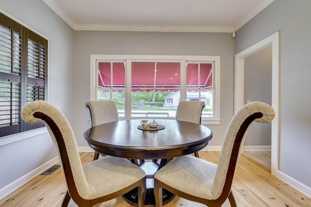 574 SW Newberry St, Aiken, SC 29801 - dining space with healthy amount of natural light, light wood finished floors, and crown molding