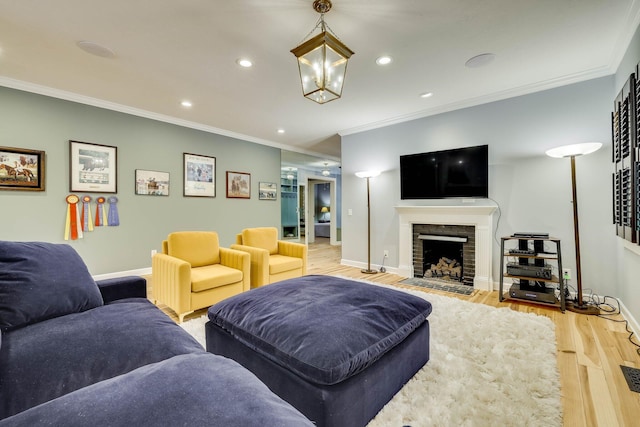 574 SW Newberry St, Aiken, SC 29801 - living room with light wood-style flooring, crown molding, recessed lighting, a fireplace with flush hearth, and a chandelier