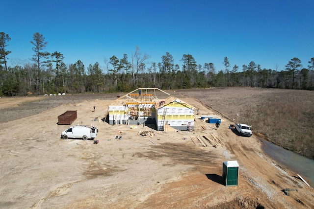drone / aerial view featuring a wooded view