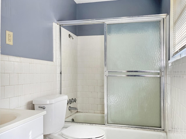 10236 S Ga Highway 23, Girard, GA 30426 - full bathroom featuring vanity, toilet, bath / shower combo with glass door, and tile walls