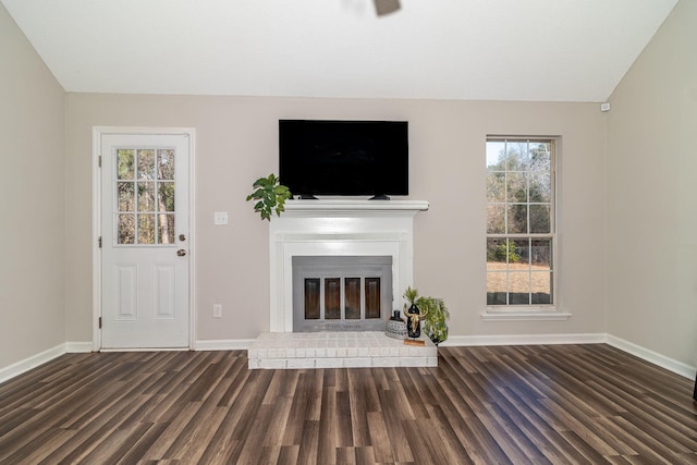 unfurnished living room featuring dark hardwood / wood-style flooring and vaulted ceiling