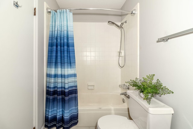 bathroom featuring shower / tub combo and toilet