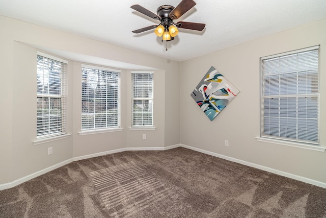 spare room featuring ceiling fan and carpet