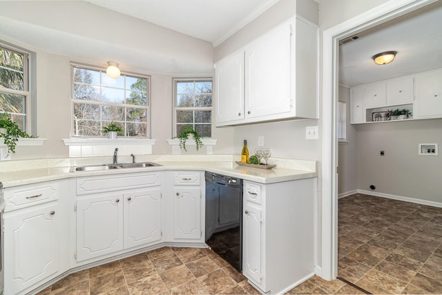 kitchen featuring dishwasher, sink, and white cabinets