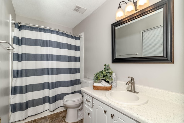 bathroom featuring vanity, a textured ceiling, curtained shower, and toilet