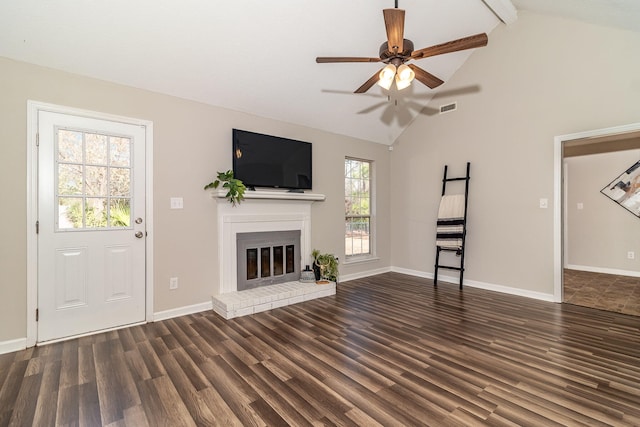 unfurnished living room featuring dark wood-type flooring, high vaulted ceiling, beamed ceiling, ceiling fan, and a fireplace