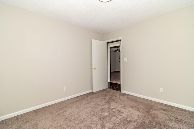 unfurnished room with carpet floors and a textured ceiling